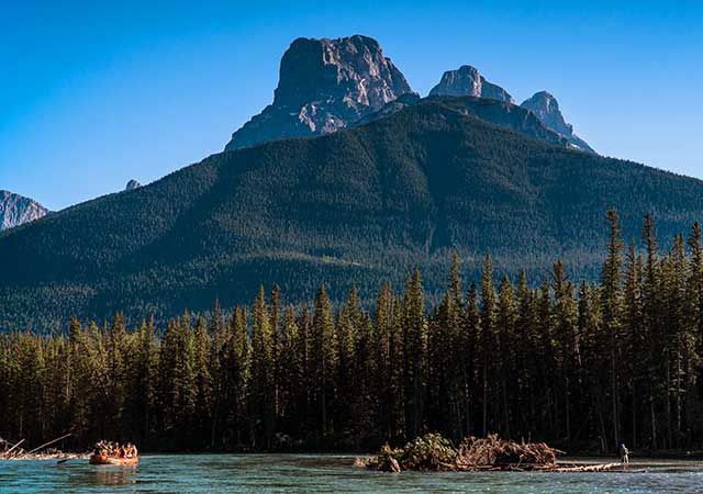 A raft on the river below the Three Sisters Mountains