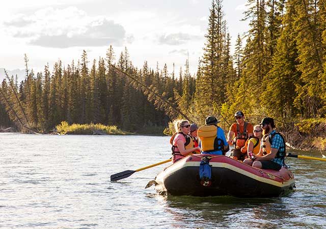 A group on a raft in the evening light.