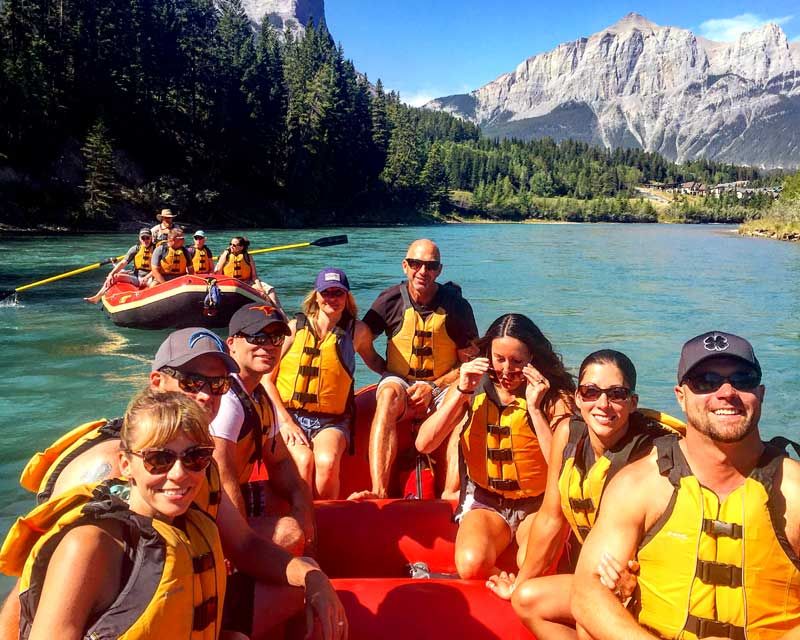 A group of people in rafts on a sunny day