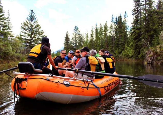 A raft guide telling stories to guests on a raft